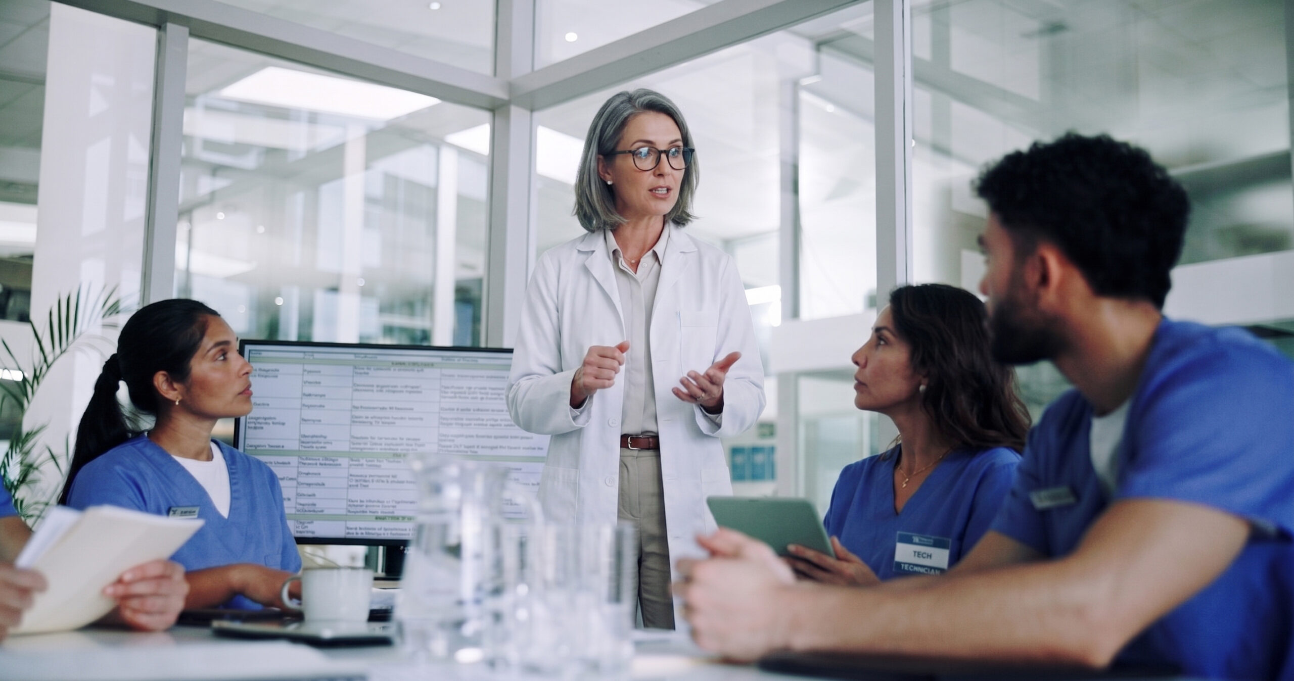 Medical director in a lab coat talking